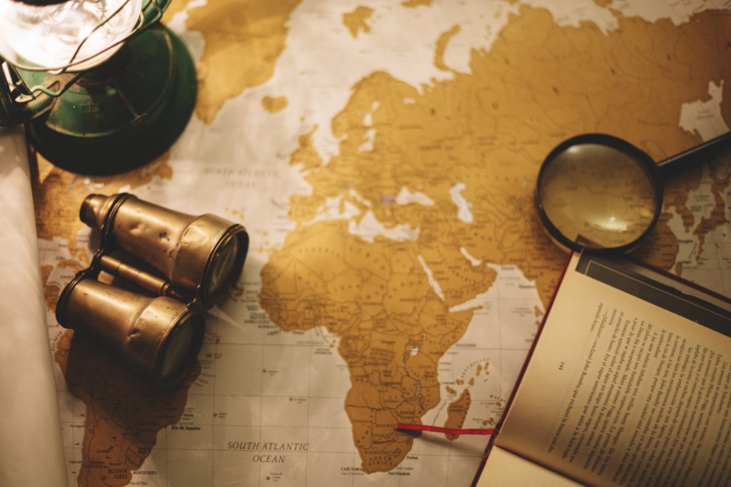binoculars and magnifying glass on map